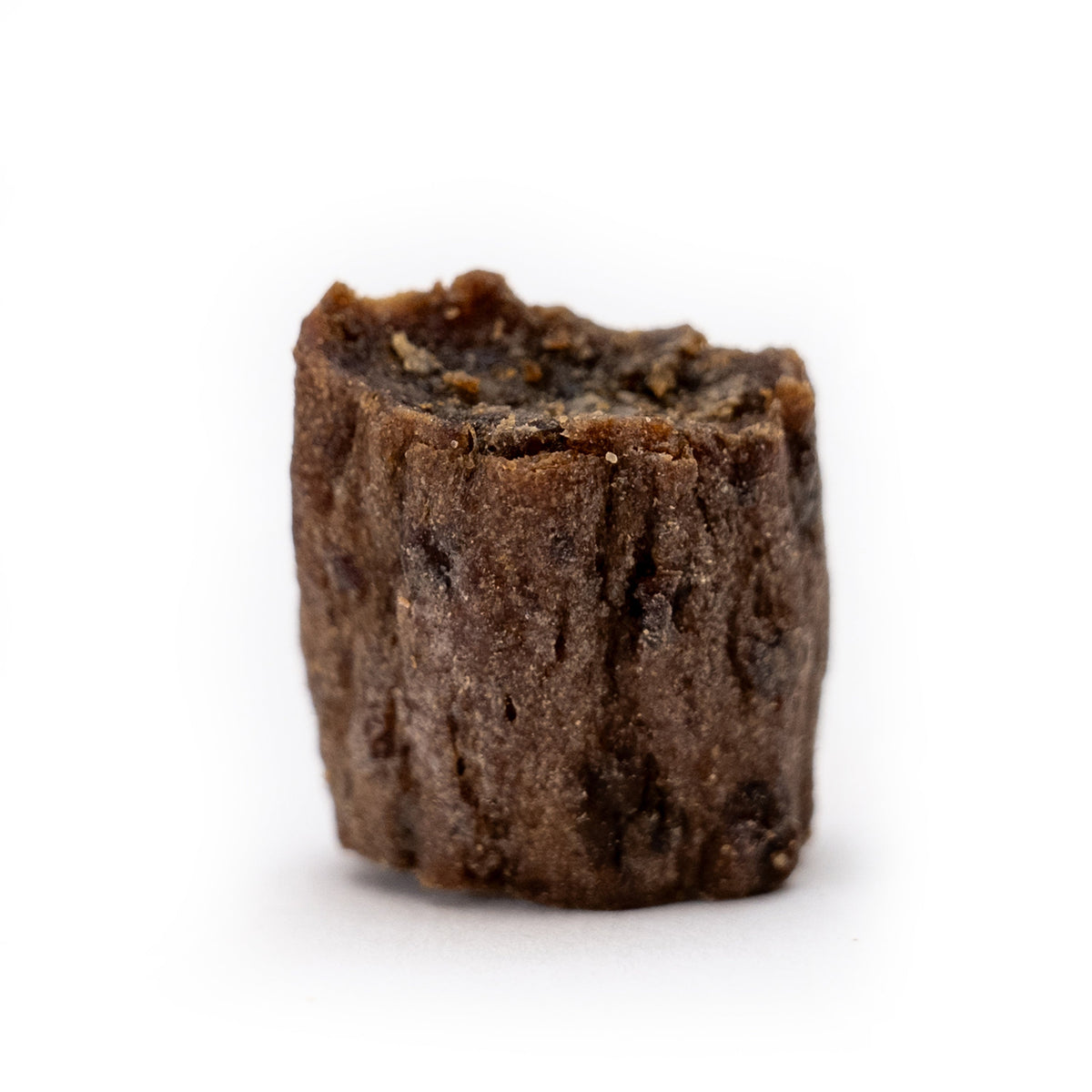 Close-up of single freeze-dried beef bite nib dog treat - high-protein training reward from HoodHound